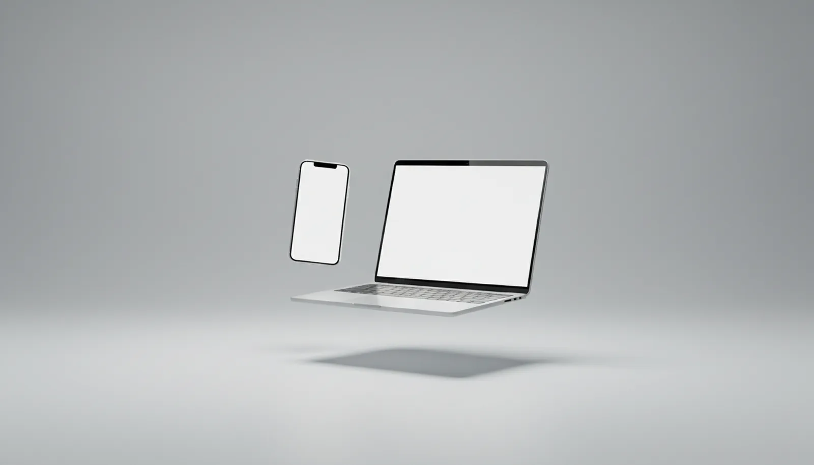 Laptop und Handy schweben über einer hellen Fläche